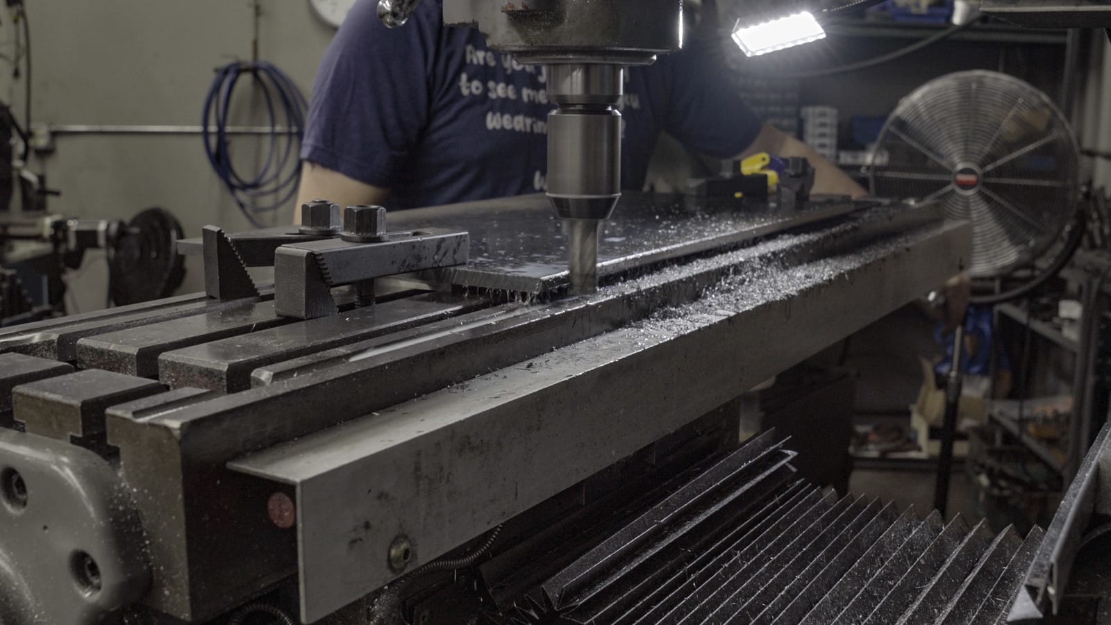Student operating CNC machining equipment