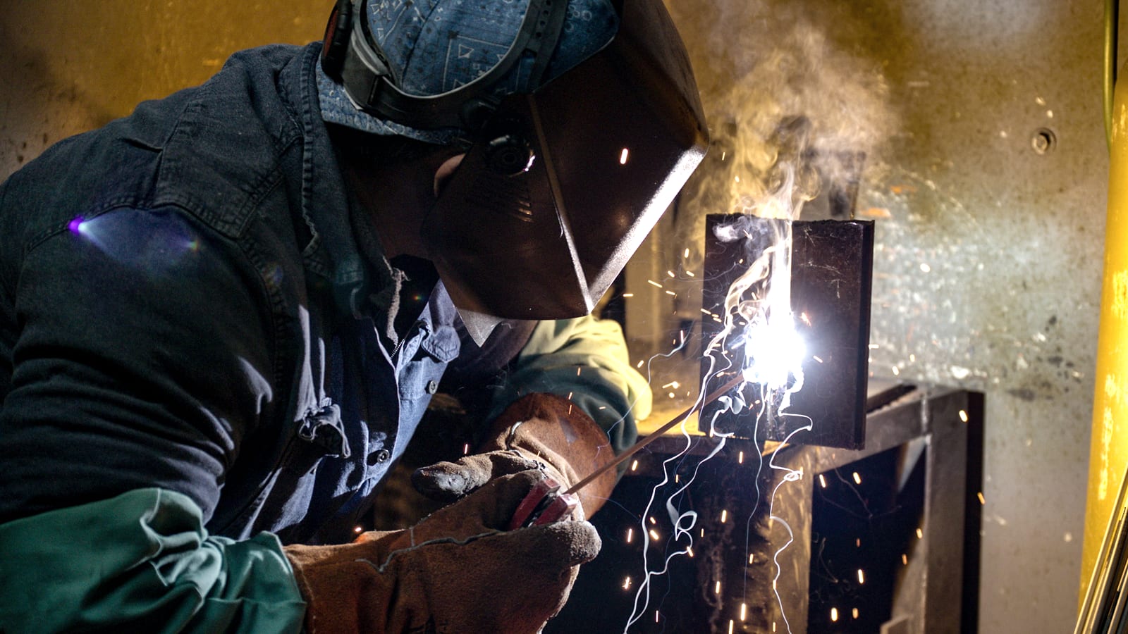 Student welding in protective gear